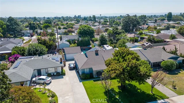 an aerial view of a house with garden space and street view