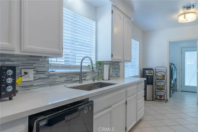 a kitchen with a sink and a stove top oven