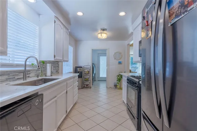 a kitchen with a sink appliances and cabinets