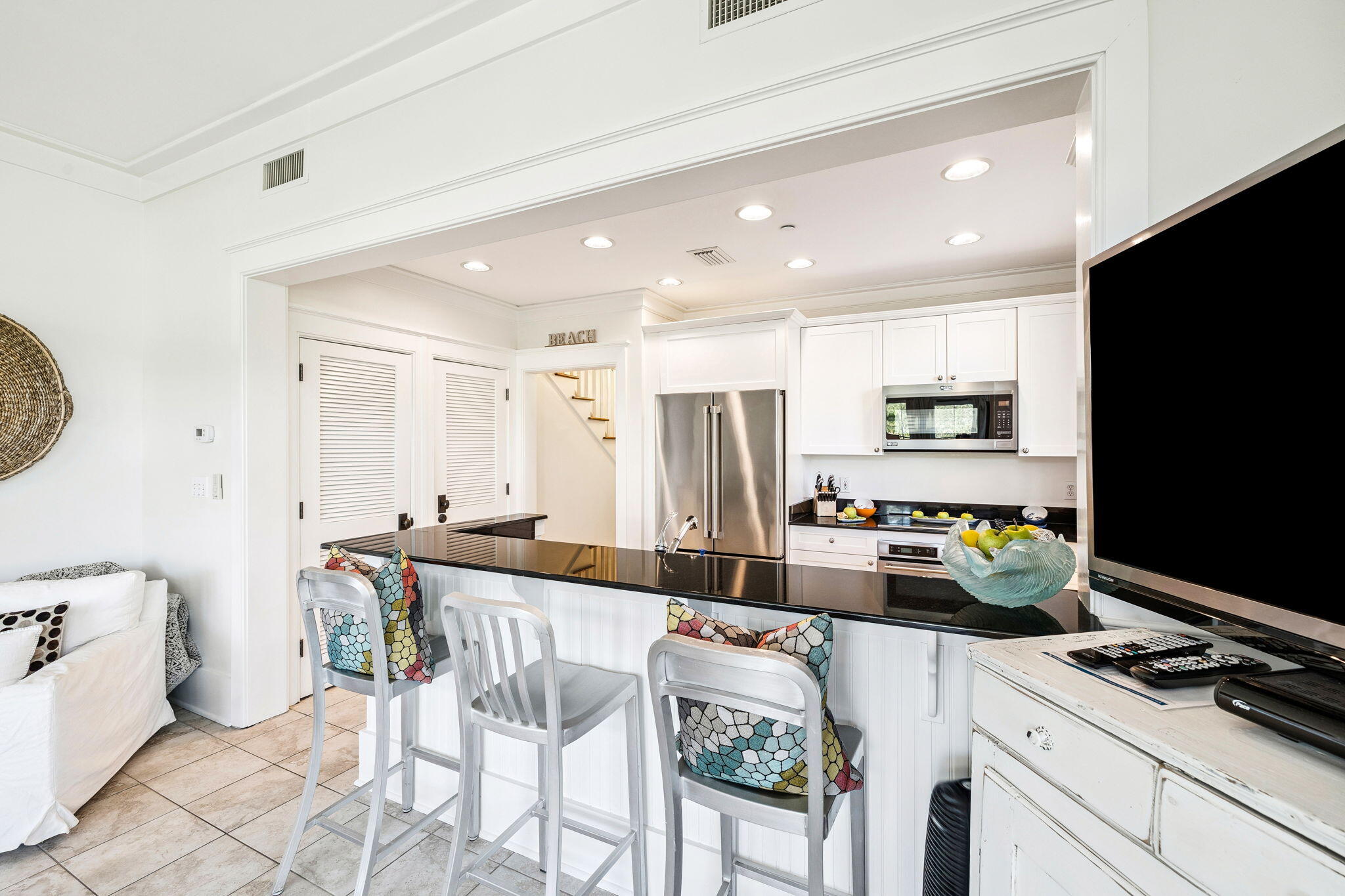 1640 East County Highway 30A, Unit 302 Santa Rosa Beach, FL 32459 - Photo 14 of 64 a kitchen with stainless steel appliances kitchen island granite countertop a sink and cabinets