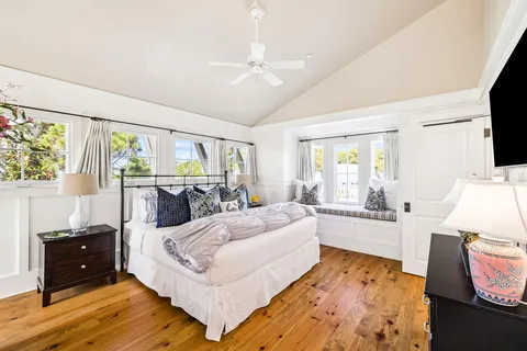 a bed sitting in a bedroom next to a window