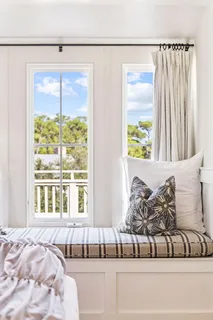 a view of a balcony with wooden chairs
