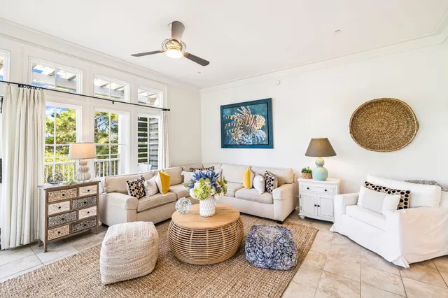 a living room with furniture and view of kitchen