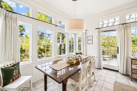 a view of a a dining room with furniture window and wooden floor