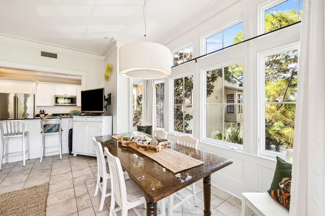 a kitchen with stainless steel appliances granite countertop a stove top oven a sink a refrigerator and white cabinets with wooden floor