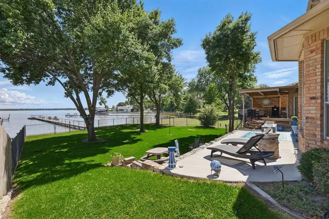 a view of a patio with chairs and a big yard