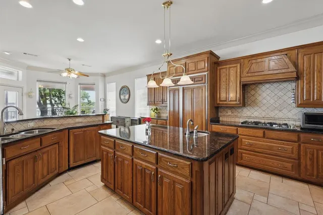 a kitchen with stainless steel appliances granite countertop a sink stove and cabinets