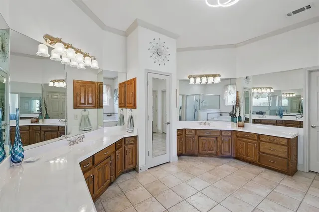 a large bathroom with a large tub sink and double vanity