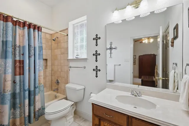 a bathroom with a sink vanity granite toilet and a mirror