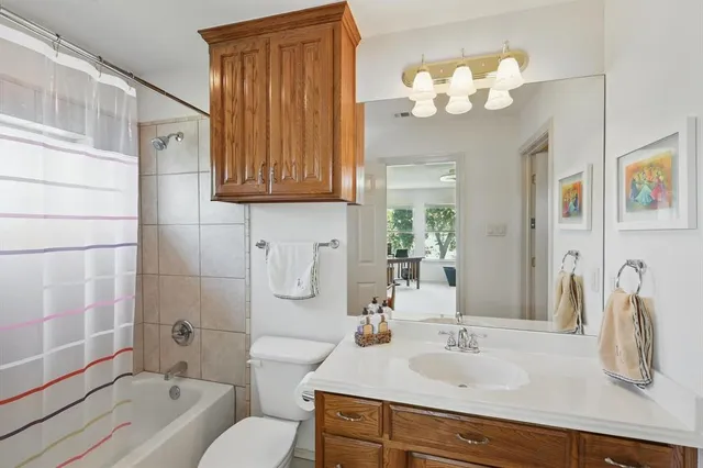 a bathroom with a sink a toilet and bathtub