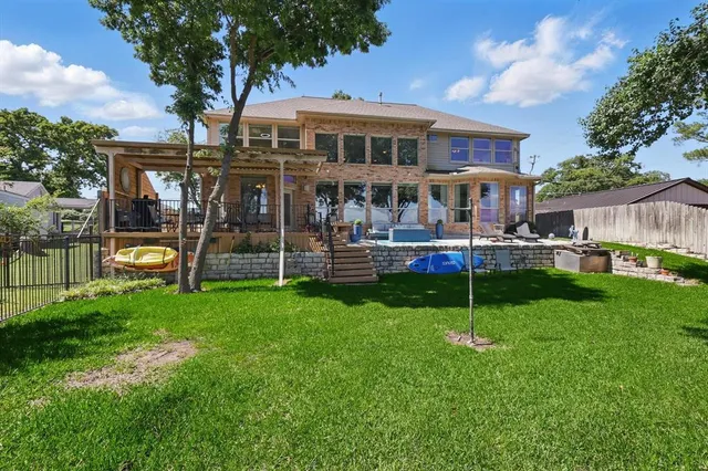 a front view of a house with garden and a patio