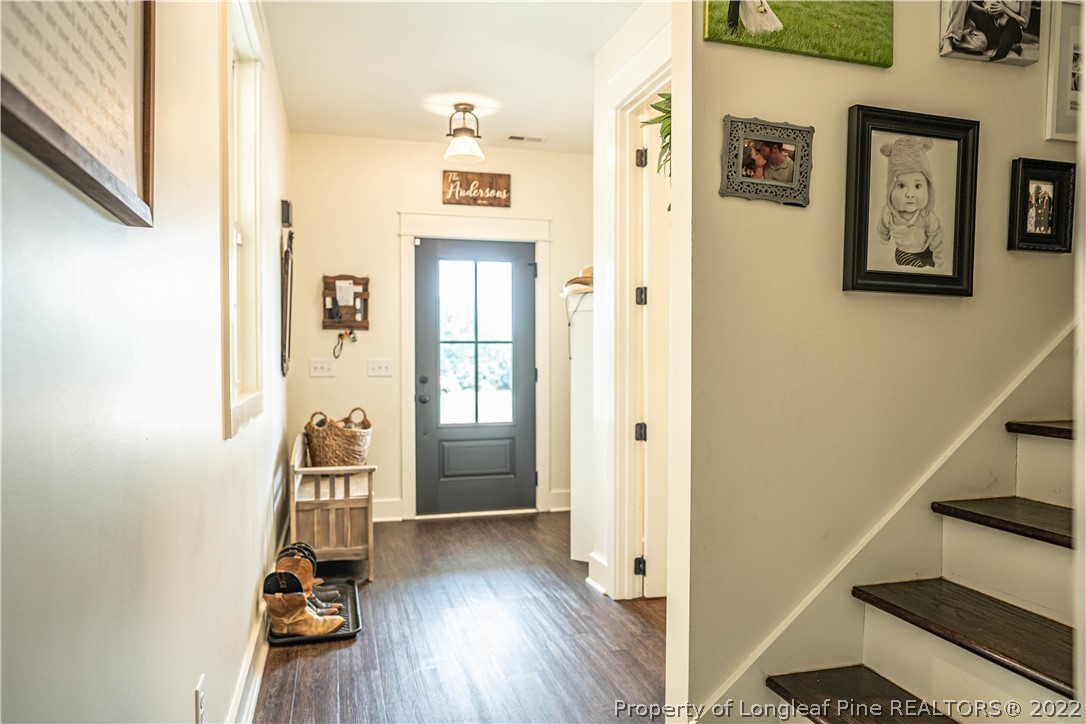 491 Stage Road Carthage, NC 28327 - Photo 11 of 47 a view of a hallway with wooden floor and staircase