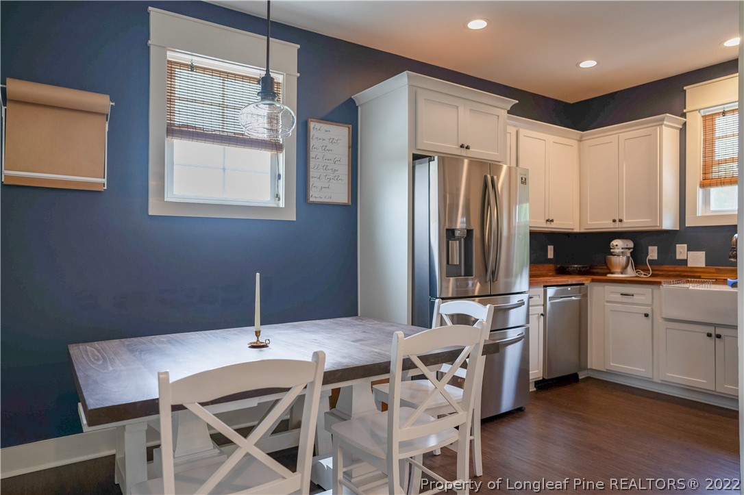 491 Stage Road Carthage, NC 28327 - Photo 17 of 47 a kitchen with stainless steel appliances kitchen island granite countertop a dining table chairs and a refrigerator