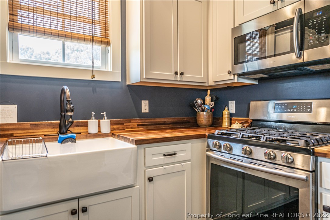 491 Stage Road Carthage, NC 28327 - Photo 19 of 47 a kitchen with stainless steel appliances granite countertop a stove and a sink