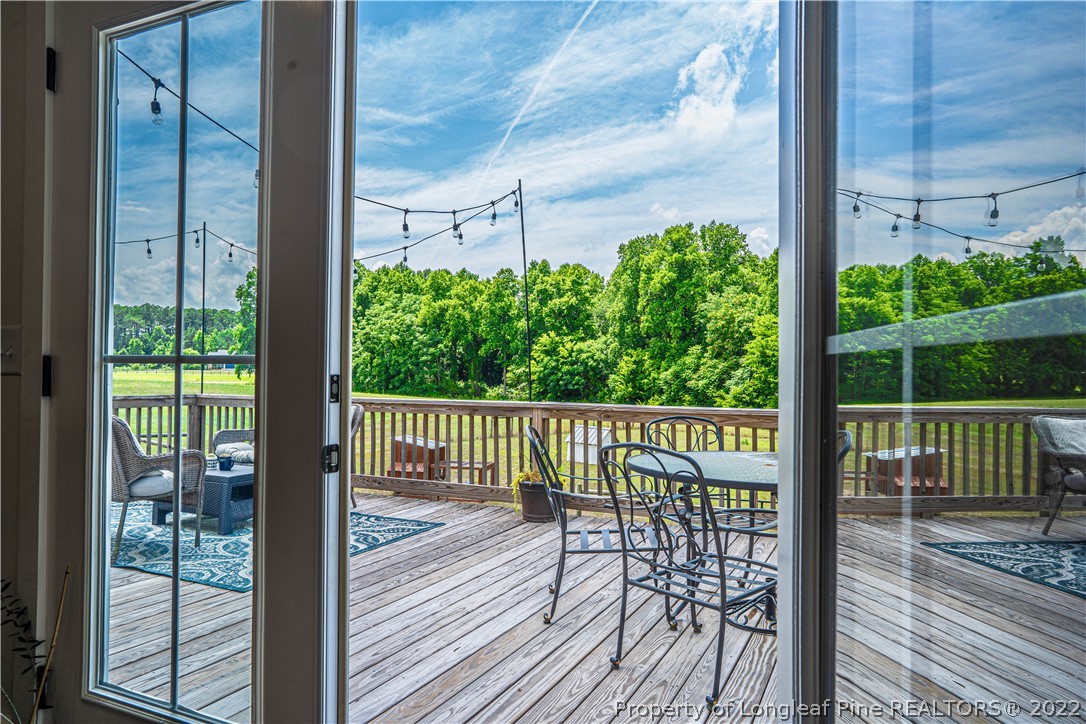 491 Stage Road Carthage, NC 28327 - Photo 28 of 47 a view of a balcony with floor to ceiling window wooden floor