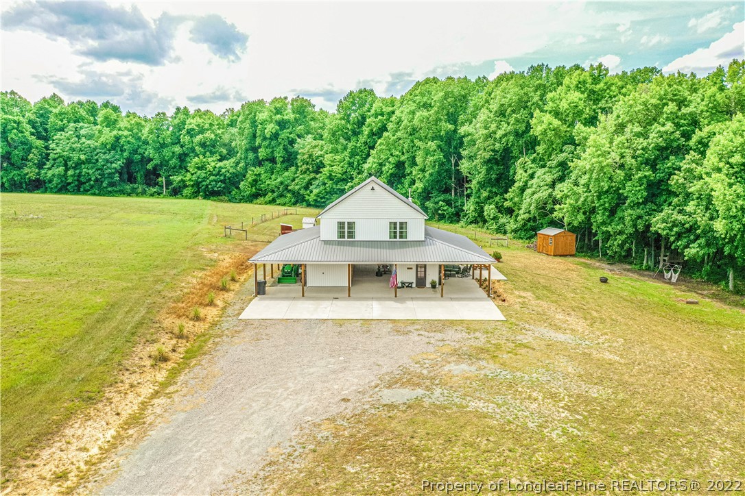 491 Stage Road Carthage, NC 28327 - Photo 4 of 47 a white house with a big yard and large trees with wooden fence