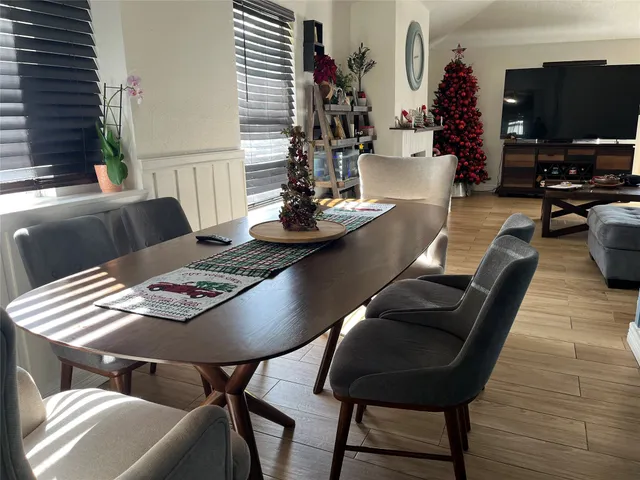 a view of a dining room with furniture and wooden floor