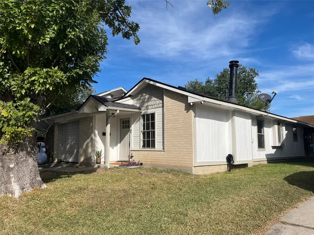 a view of a white house with a yard