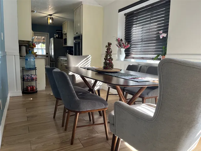 a view of a dining room with furniture and wooden floor