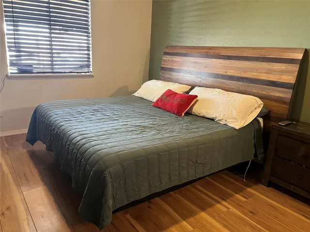 a bed sitting in a bedroom next to a window