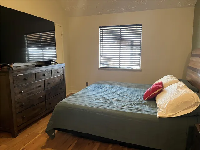 a bed sitting in a bedroom next to a window