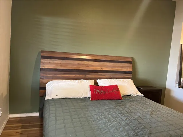 a bedroom with a bed and window