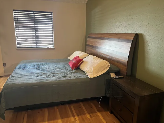 a bedroom with a bed and a dresser