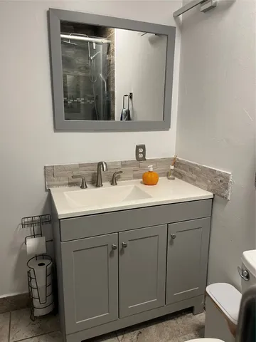 a white toilet sitting next to a bathroom sink
