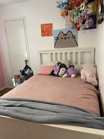 a bed sitting in a bedroom next to a window