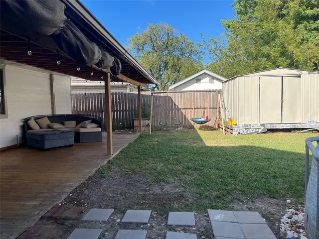 a view of a backyard with small cabin