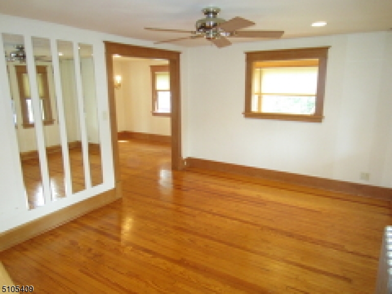 1 Myrtle Avenue Madison, NJ 07940 - Photo 2 of 21 a view of an empty room with wooden floor and a window