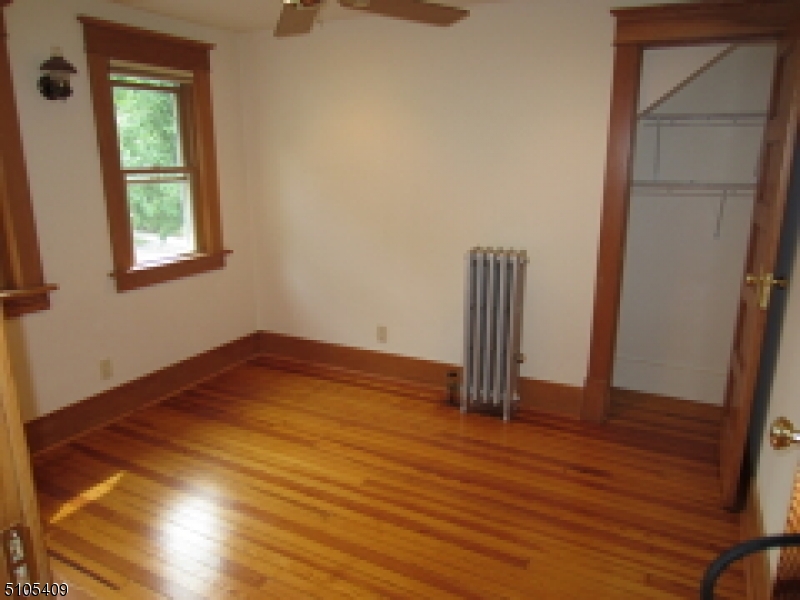 1 Myrtle Avenue Madison, NJ 07940 - Photo 11 of 21 an empty room with wooden floor and a window