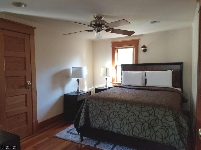 1 Myrtle Avenue Madison, NJ 07940 - Photo 17 of 21 a bedroom with a bed and a chandelier