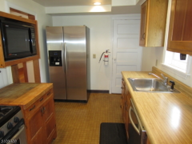 1 Myrtle Avenue Madison, NJ 07940 - Photo 7 of 21 a kitchen with a sink and a refrigerator