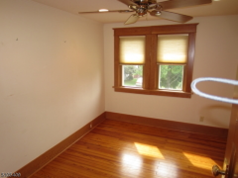 1 Myrtle Avenue Madison, NJ 07940 - Photo 9 of 21 a view of an empty room with a window and wooden floor