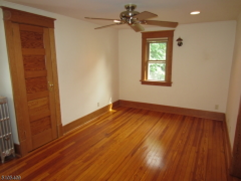 1 Myrtle Avenue Madison, NJ 07940 - Photo 10 of 21 a view of empty room with wooden floor and fan