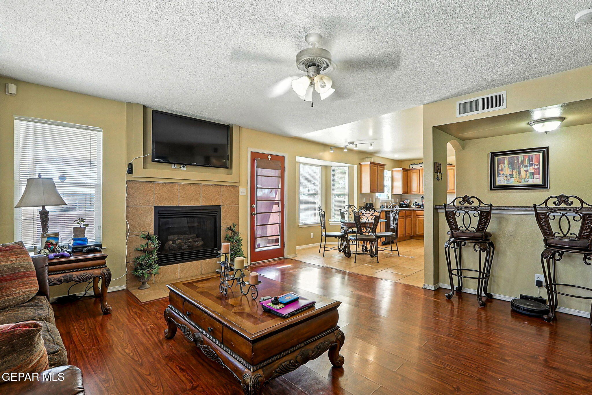 6505 Berringer Street El Paso, TX 79932 - Photo 12 of 51 a living room with furniture a flat screen tv and kitchen view
