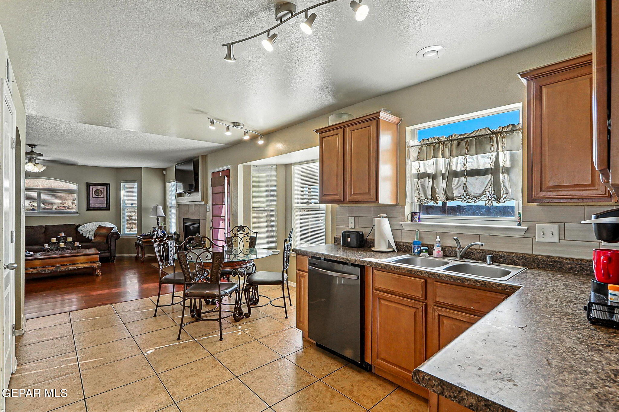6505 Berringer Street El Paso, TX 79932 - Photo 19 of 51 a kitchen with stainless steel appliances granite countertop a sink dishwasher stove and cabinets with wooden floor