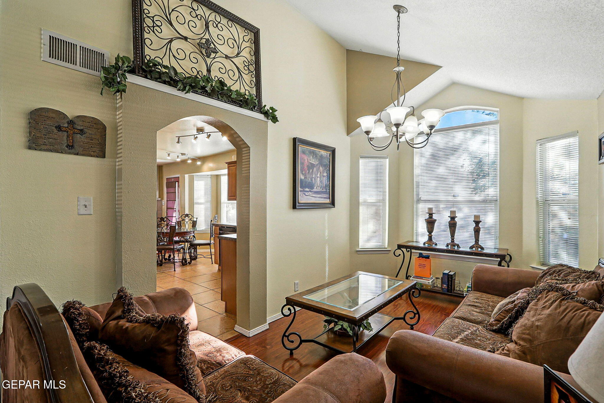 6505 Berringer Street El Paso, TX 79932 - Photo 10 of 51 a living room with furniture a chandelier and a fireplace