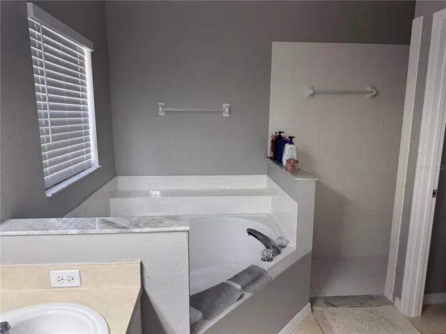 a bathroom with a granite countertop sink and a toilet