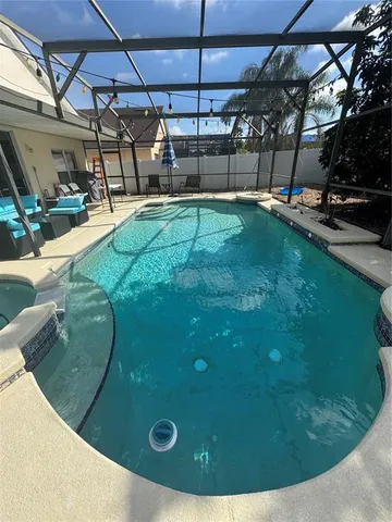 a backyard of a house with yard and outdoor seating