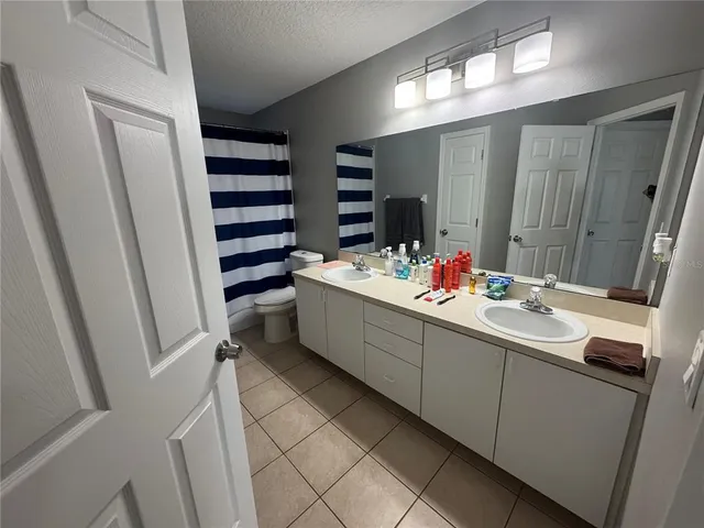 a bedroom with a bed and a television