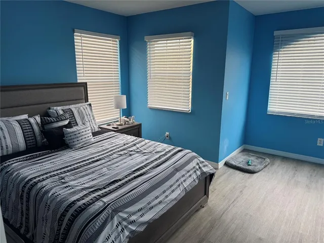 a view of a livingroom with wooden floor and a window