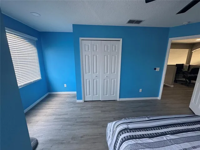 a bedroom with a bed and window