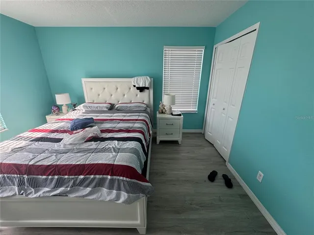 a bedroom with a bed and a dresser