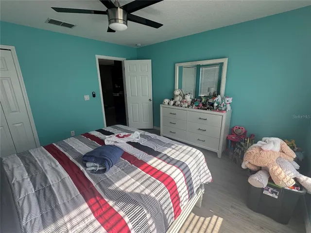 a bed sitting in a bedroom next to a window