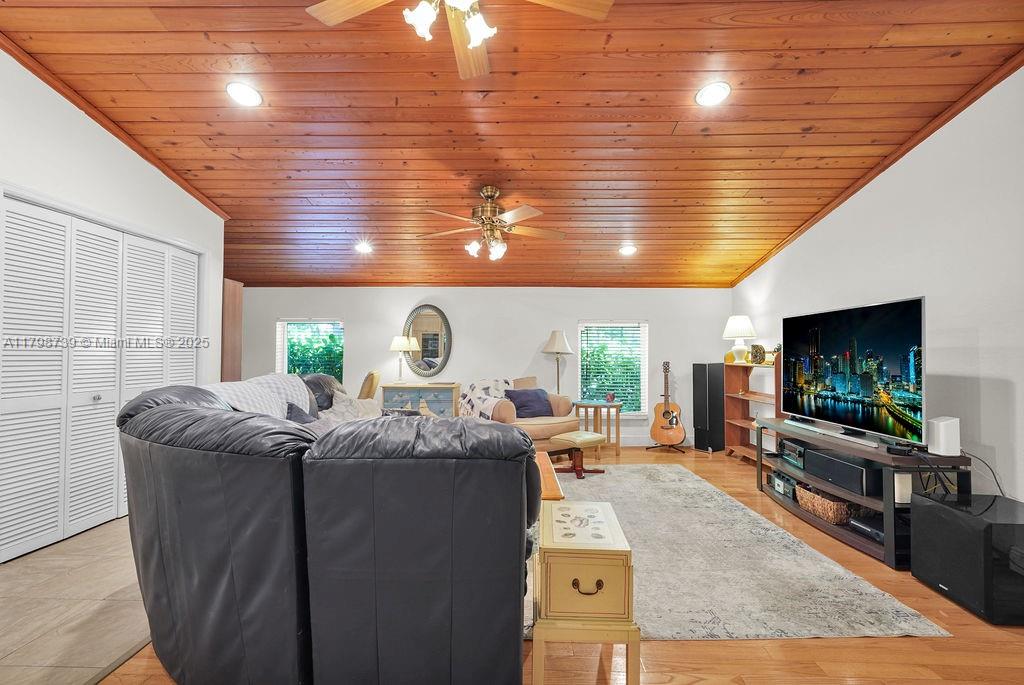 6551 Southwest 126th Street Pinecrest, FL 33156 - Photo 11 of 39 a living room with furniture and a flat screen tv