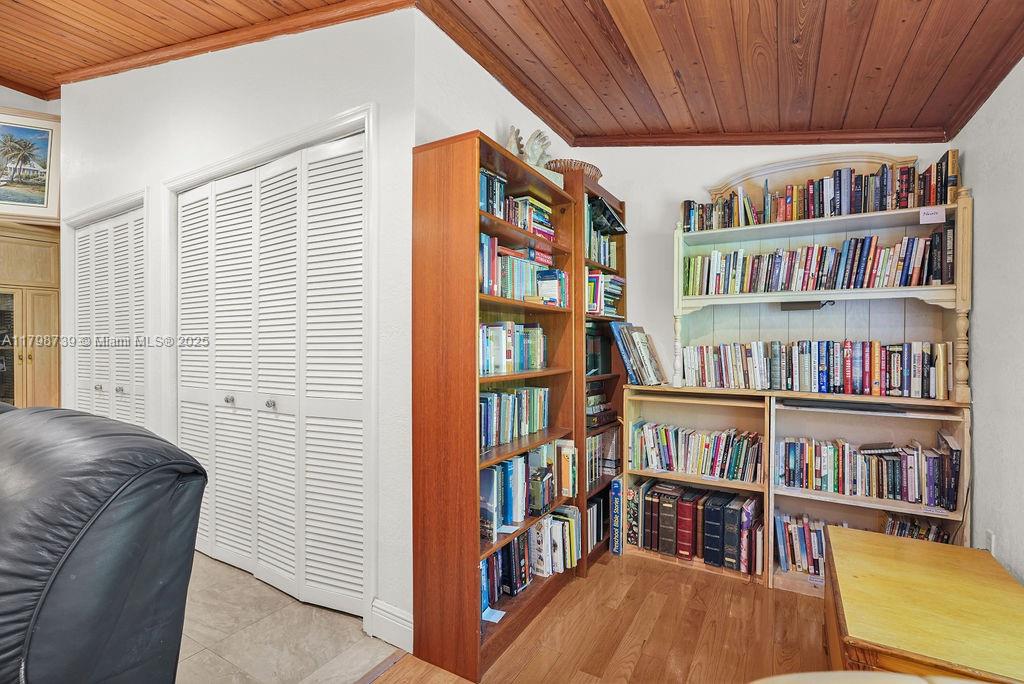 6551 Southwest 126th Street Pinecrest, FL 33156 - Photo 13 of 39 a living room with bookshelf and a window