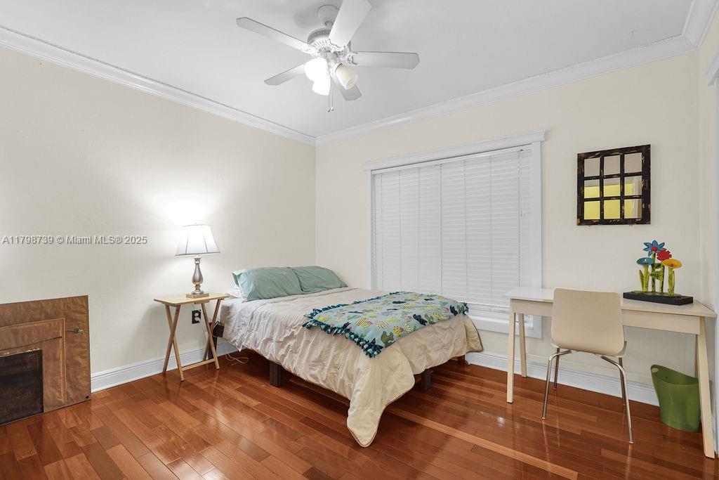 6551 Southwest 126th Street Pinecrest, FL 33156 - Photo 19 of 39 a bedroom with a bed and a table in it