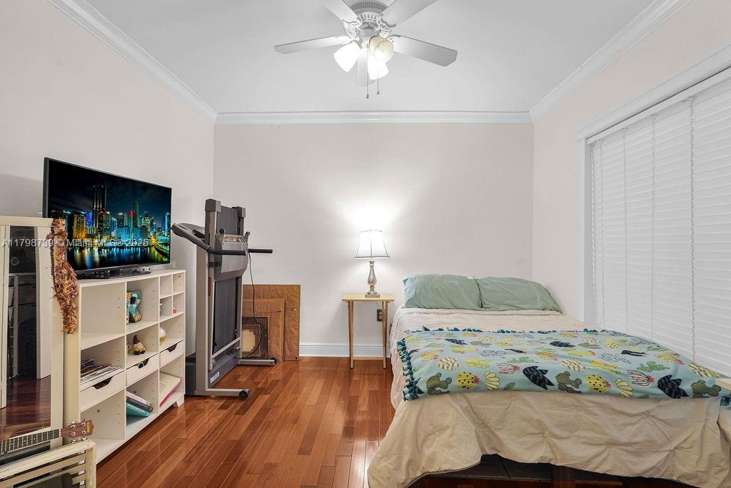 6551 Southwest 126th Street Pinecrest, FL 33156 - Photo 20 of 39 a bedroom with a bed and a flat tv screen on the dresser